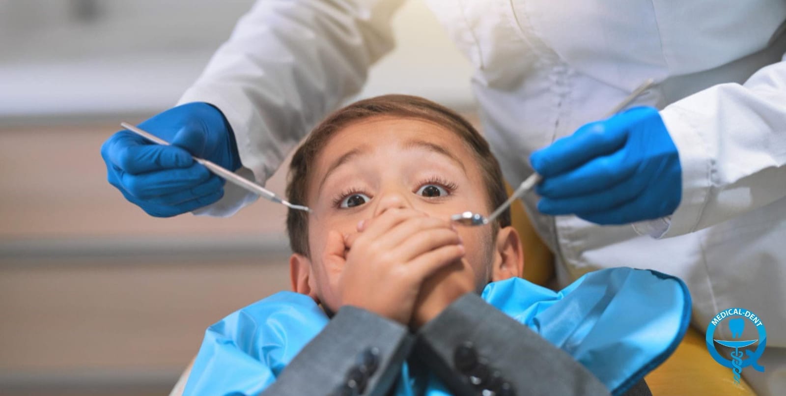 A child covering their mouth during a dental examination