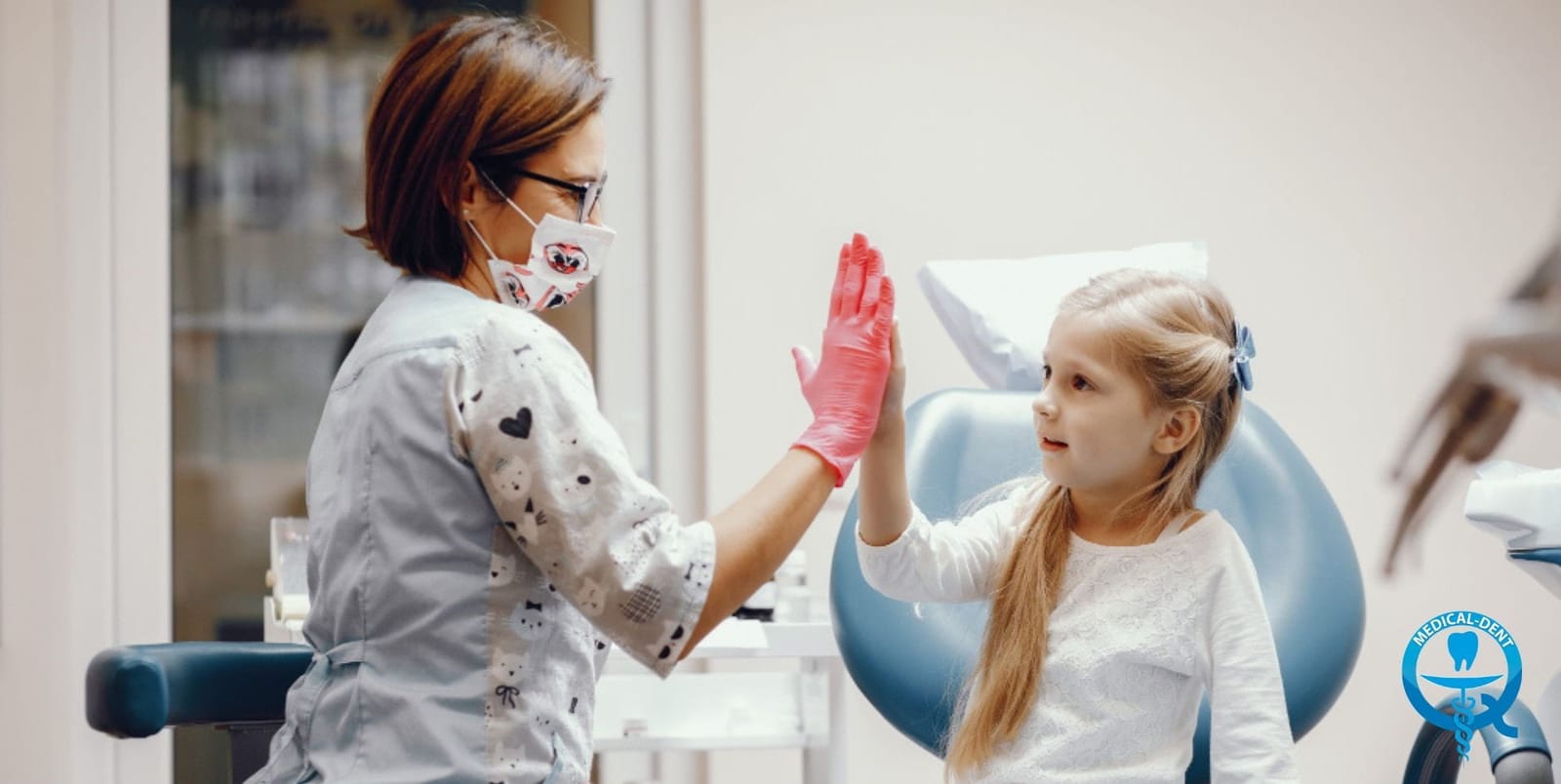 A child and dental professional sharing a high-five