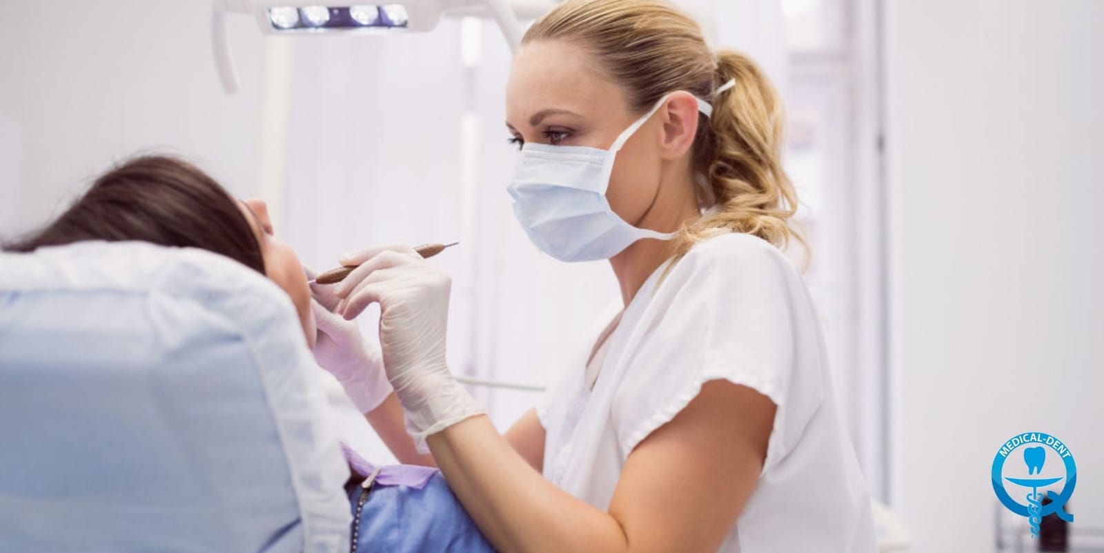 A dental professional treating a patient in a dental chair