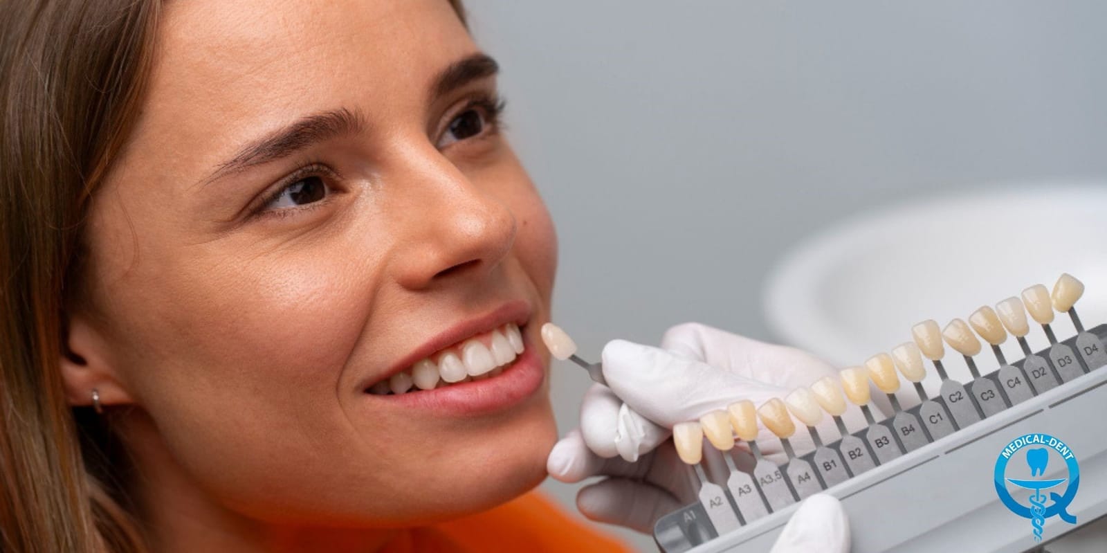 A clinician comparing a shade guide with a patient’s teeth
