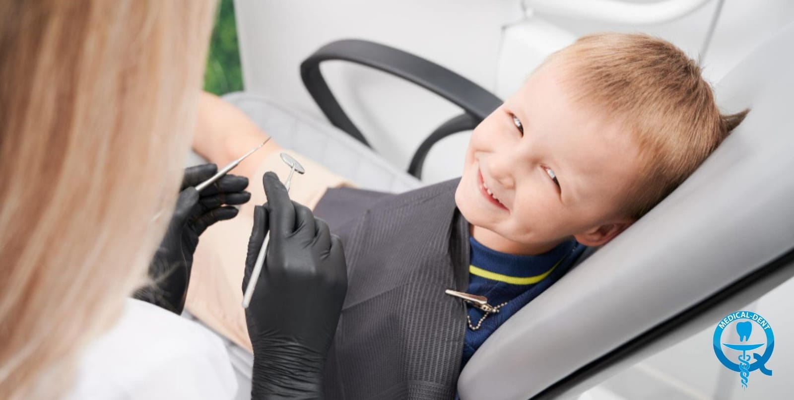 A boy having his teeth examined in a dental chair